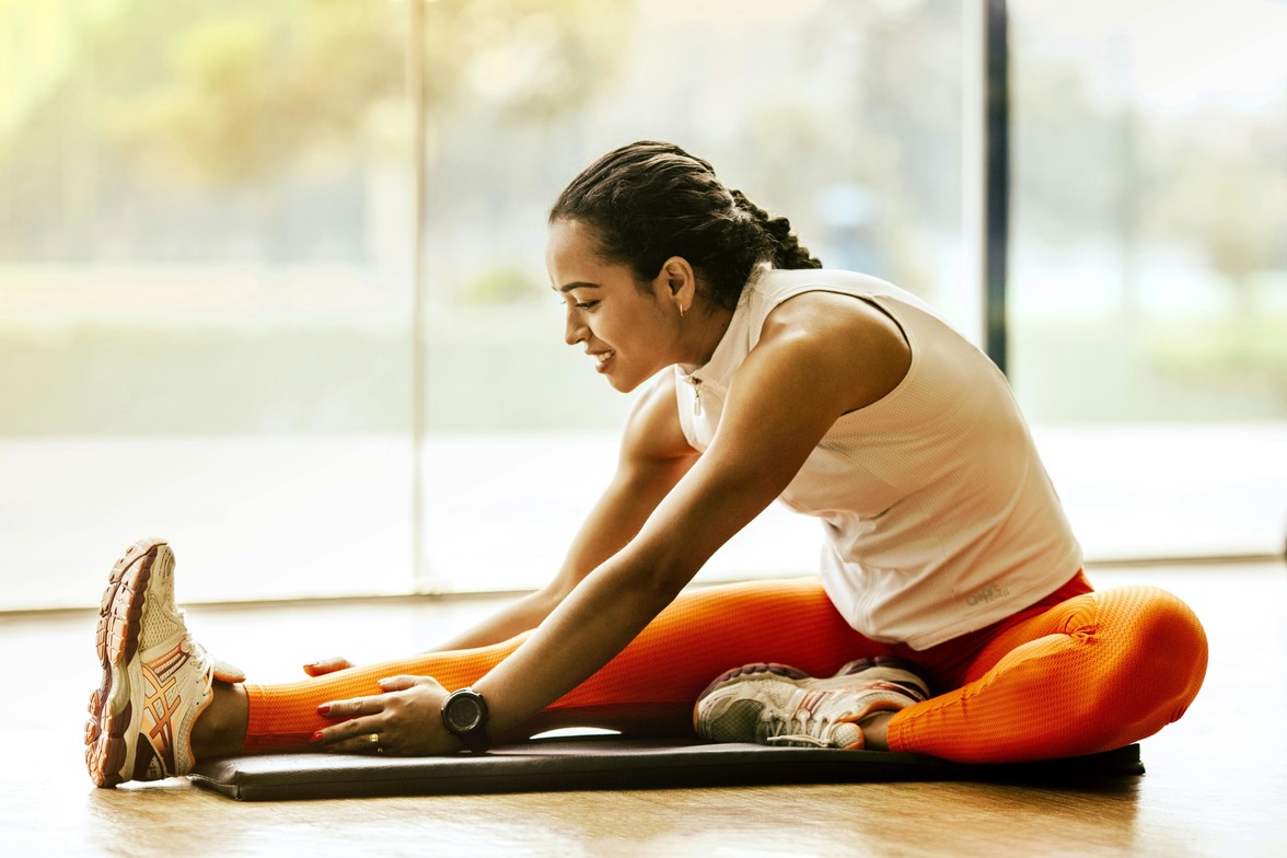 Woman stretching to help her flexibility following a chiropractic adjustment